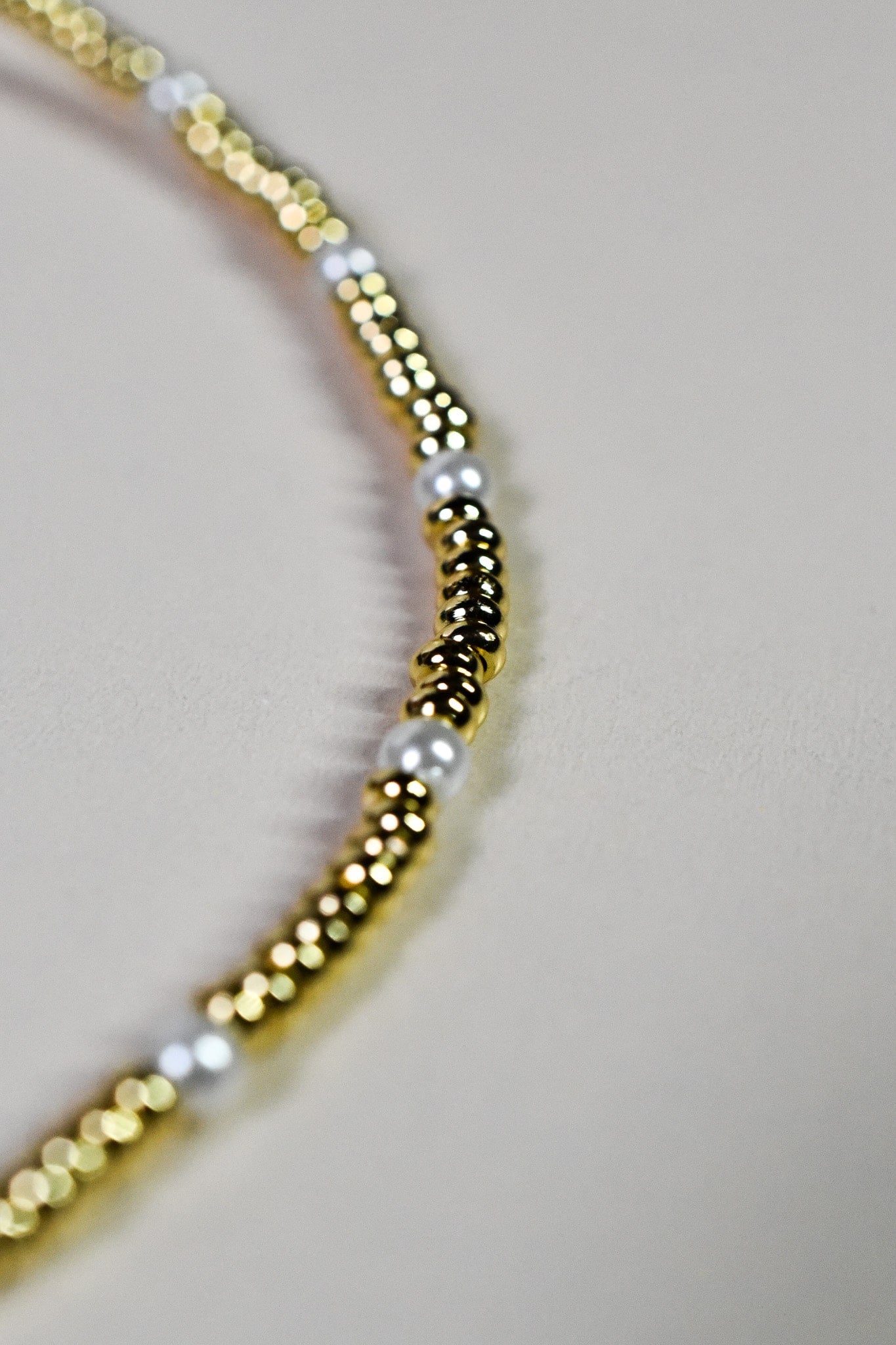 Close-up of the luxurious INDIVIJWL Gold and Pearl Beaded Choker Necklace, featuring 24k gold-filled spacer beads and shell pearls. Tarnish-resistant and 16 inches in length, symbolizing emotional balance and timeless beauty.