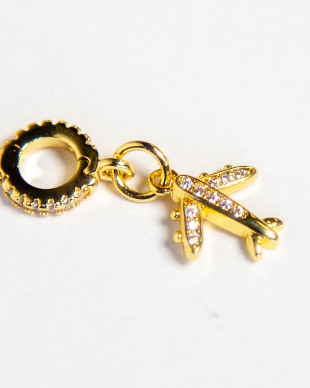 INDIVIJWL gold airplane charm featuring micro paved cubic zirconia and a versatile removable bail holder, designed for personalized jewelry collections. A perfect addition to any charm bracelet or layered necklace.