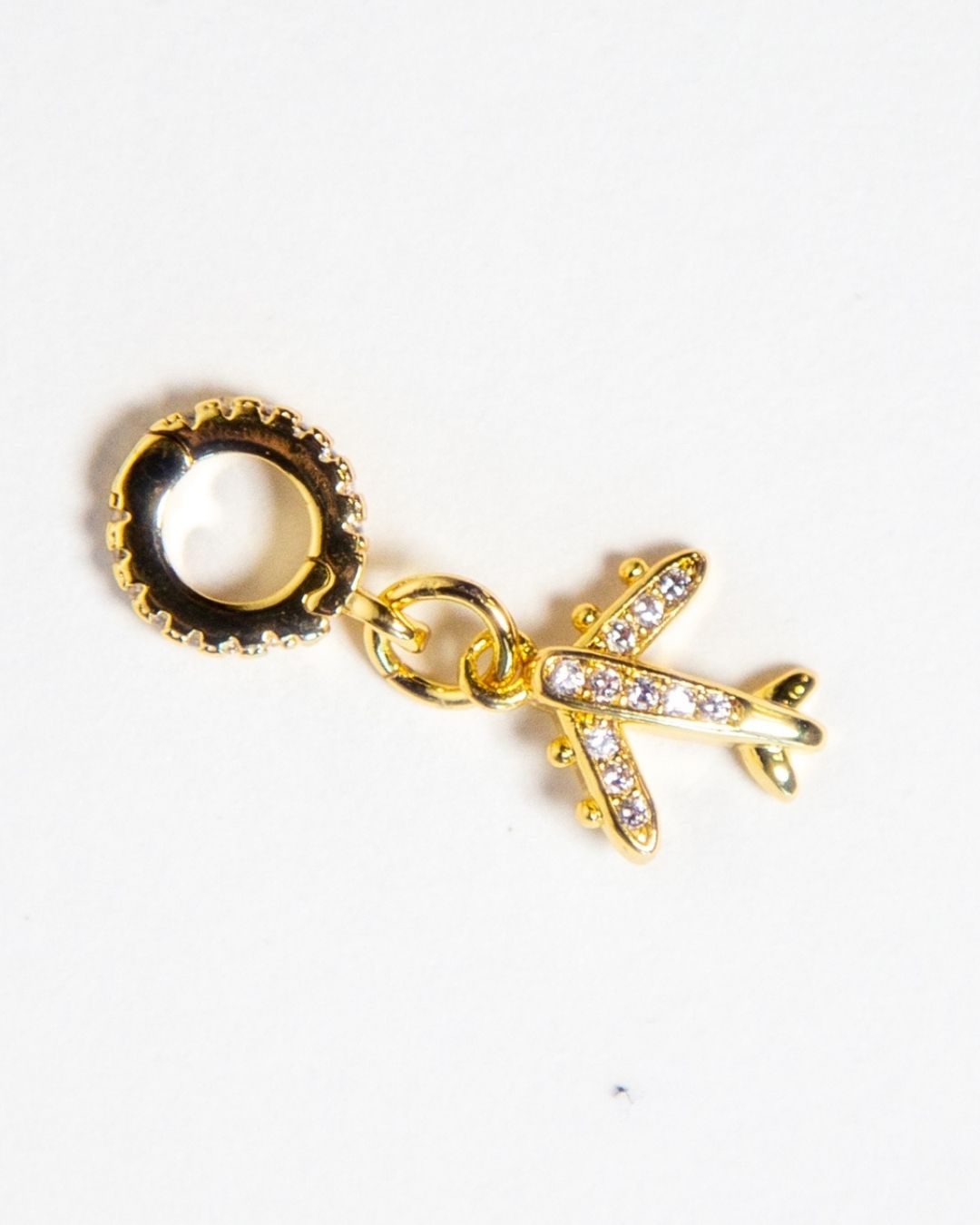 Elegant 6K gold filled airplane charm from INDIVIJWL, adorned with micro paved cubic zirconia and a removable, interchangeable bail holder. Ideal for creating customizable travel-inspired necklaces and bracelets.