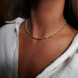 INDIVIJWL Gold and Pearl Beaded Choker Necklace shown on a model, featuring 24k gold-filled 3mm spacer beads and delicate shell pearls. This 16-inch tarnish-resistant choker is designed to enhance natural beauty and symbolize emotional balance.