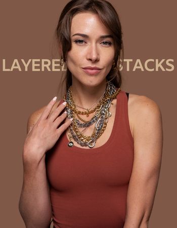 Model wearing a layered stack of gold and silver chain necklaces from INDIVIJWL, featuring intricate charms and customizable designs for a bold, stylish look. Perfect for personalized jewelry layering.