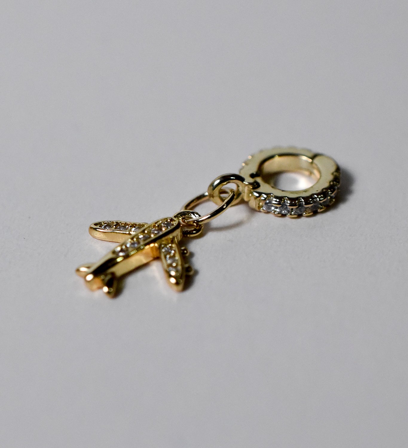 INDIVIJWL airplane charm with 6K gold filled micro paved cubic zirconia, featuring a removable and interchangeable bail charm holder for easy customization. Perfect for travel-themed jewelry or charm necklaces and bracelets.