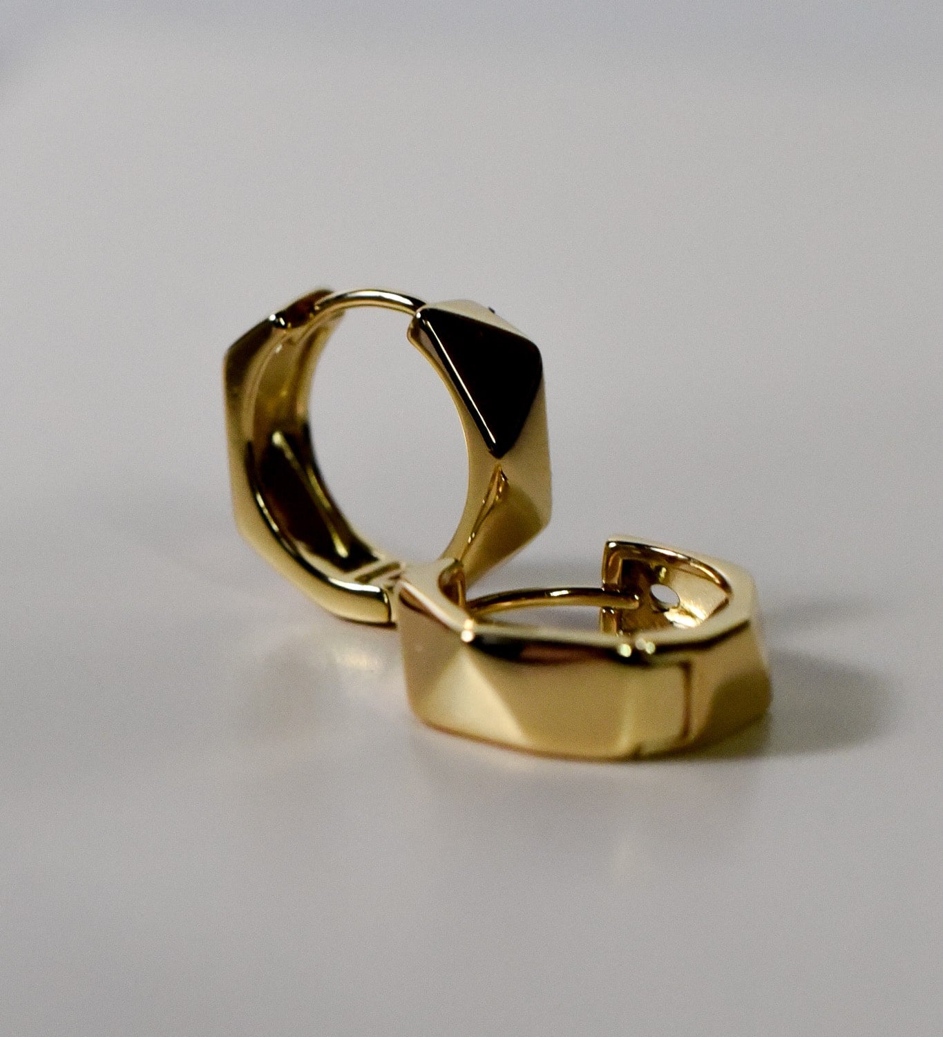 Flatlay of INDIVIJWL chunky spiked gold hoop earrings, featuring bold geometric spikes and a luxurious gold-filled finish. Perfect for statement-making, edgy jewelry styles